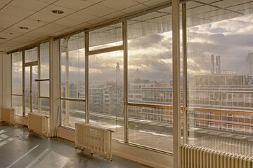 Empty office room with big windows looking out on the city of Ghent