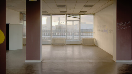 Empty office room with big windows looking out on the city of Ghent