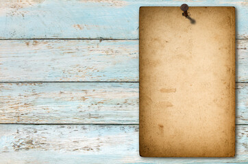 Old paper poster attached rusted nail wooden background