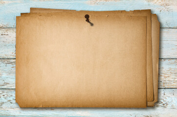 Rusted nail head attached old paper poster wooden background