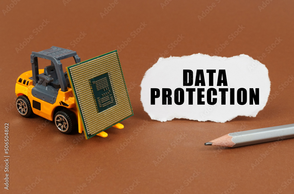 Poster On a brown surface, a forklift is transporting a processor, next to it is paper with the inscription - Data Protection