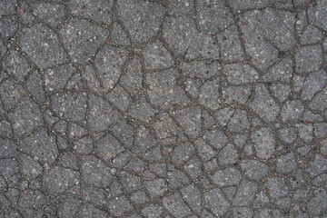 Old asphalt in cracks. Texture on the road.