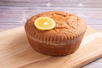 Orange cake over wooden surface, selective focus.