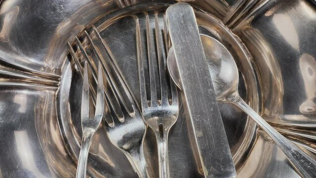 Old kitchen silverware on a bright, colored background