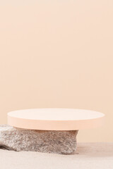 Grunge concrete stone and beige round platform podium for cosmetics or products on white beach sand background. Front view