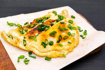 Uzbek,Tatar cuisine,cheburek with beef,pork meat,onions,greens on wooden board.Fresh baked homemade Cornish pasties,fried stews pie wrapped in shortcrust pastry.Traditional Turkish mongolian dish