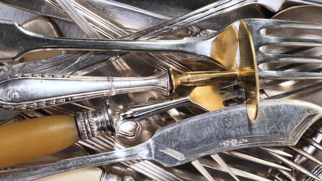 Old kitchen silverware on a bright, colored background