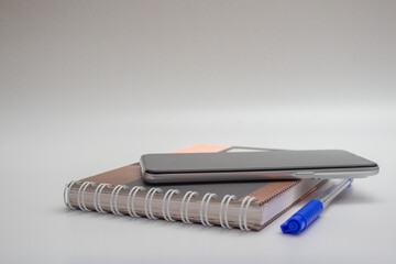 notebook, pen, phone, top view with copy space