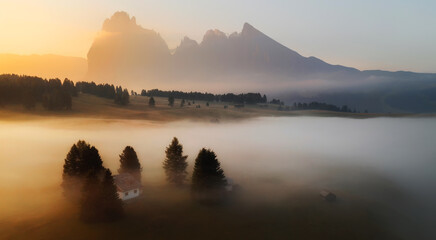 Misty sunrise in the Dolomites mountains on a summer morning
