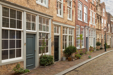 Fototapeta na wymiar Street with old houses with different facades in the center of the historic city of Dordrecht.