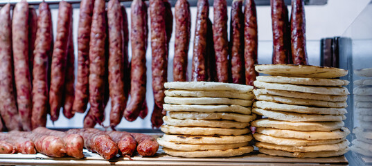panoramic photo of Colombian arepas and chorizo, in a local business