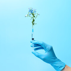 Gloved hand holding syringe with flowers, beauty injections creative concept.