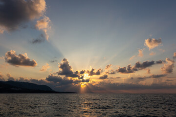 Sunset at sea, with clouds of yellow and orange tones