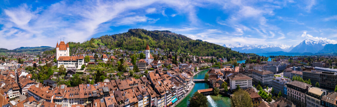 Splendid aerial panorama of Thun old town with medieval castle and Alps mountains on background. Incredible beautiful Switzerland.