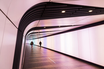 Commuters in Kings Cross light tunnel