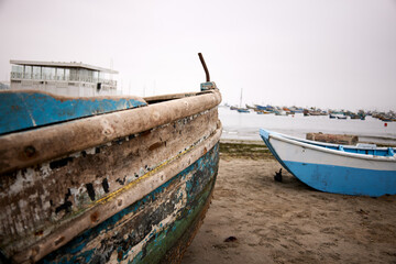 Fototapeta na wymiar Old wooden fish boat on the beach. 