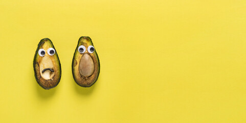 Spoiled rotten fruit vegetables cheerful avocado with yellow eyes against background copy space