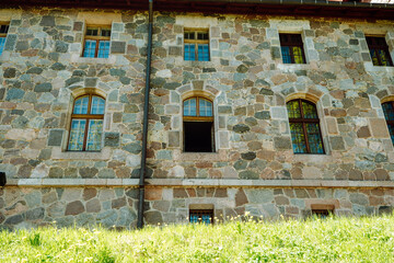 Fototapeta premium old castle stone wall with windows. one window open