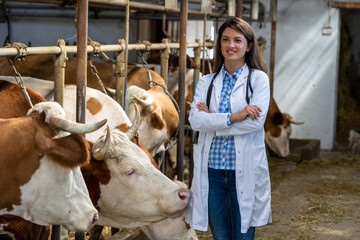 Woman veterinarian standing in stable