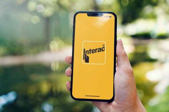 Girl In The Park Holding A Smartphone With Interac (Canadian Interbank Network) App On The Screen. Rio De Janeiro, RJ, Brazil. May 2022