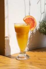 glass of orange juice and orange