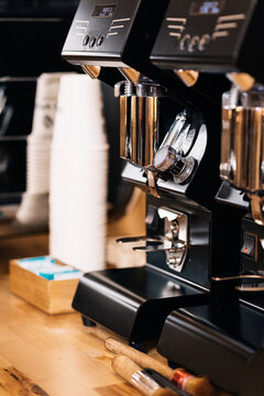 Professional coffee machines and disposable cups placed on table