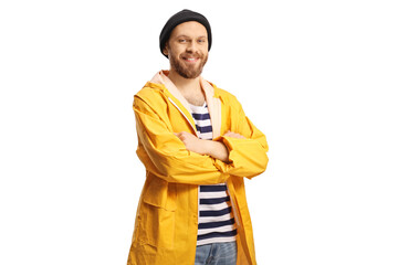 Young fisherman in a yellow raincoat posing and smiling at camera
