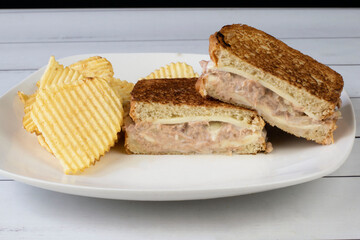 tuna melt sandwich on toasted bread  with potato chips