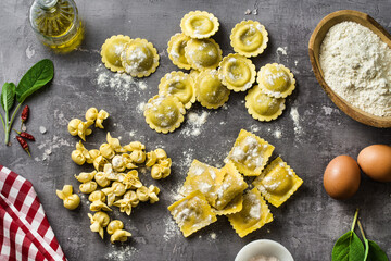 Fototapeta na wymiar different types of fresh raw italian ravioli on the table with cooking ingredients. home kitchen