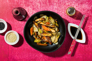 rice cake with vegetables in the plate. served with soy sauce