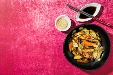 rice cake with vegetables in the plate. served with soy sauce