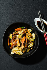 rice cake with vegetables in the plate. served with soy sauce