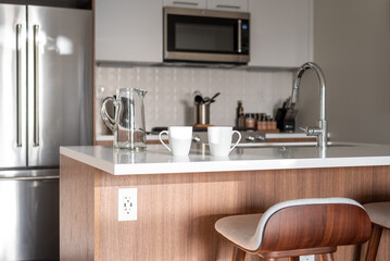 Two coffee cups on the counter in a light and bright kitchen