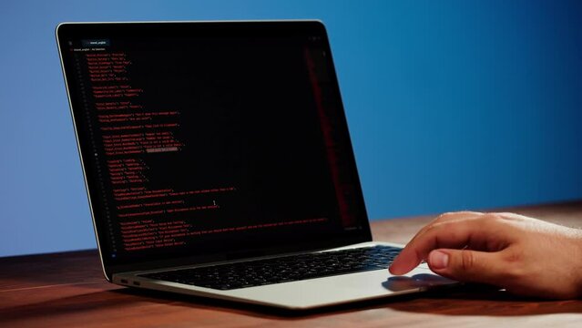Programmer using laptop. Program code and script data on the screen close-up. Hacker attack. 