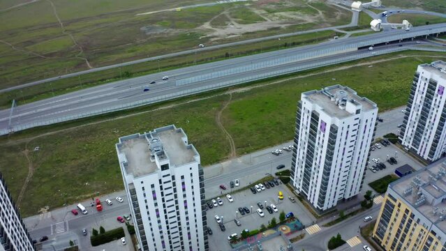 Aerial view of an apartment housing complex and parking space near buildings. Stock footage. New city sleeping area.