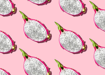 Top view photo with pitaya. Halved fresh dragon fruits on pink backdrop