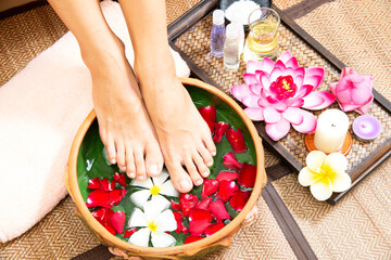 Obraz na płótnie Canvas Spa treatment and massage product for female manicure foots skin care with white flower.