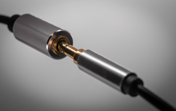 Macro closeup of 3.5 mm headphone jack be inserted suggestively