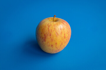 Fuji apple on blue background