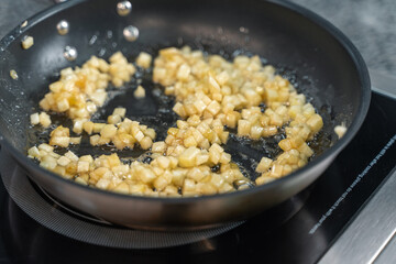 apple slices are fried in a frying pan