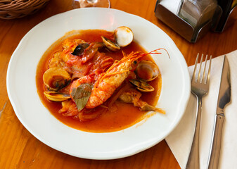 Spicy appetizer of monkfish tail a la marinera stewed with vegetables..