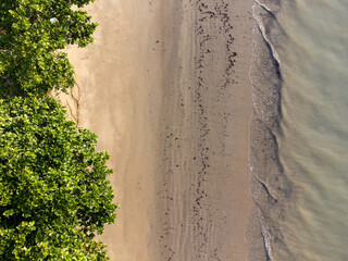 Drone top view of the beach with greenish water