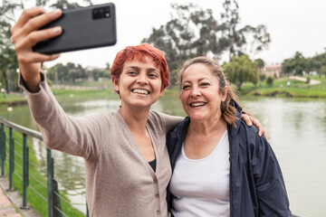 mom and daughter walking in the park and momandoce selfie