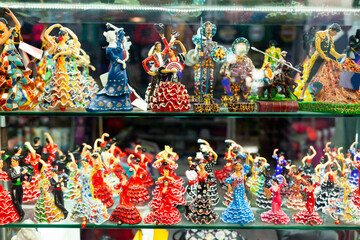 Variety of flamenco dancer figurines on souvenirs stand at market in Spain