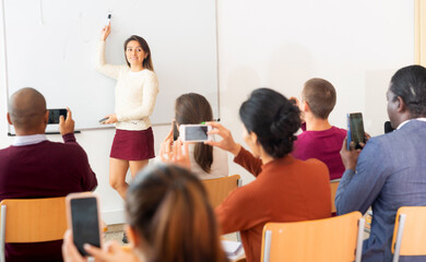 Businesswoman advertises a product in front of an audience
