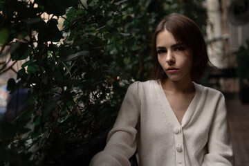 Portrait of a cute girl in the white sweater.