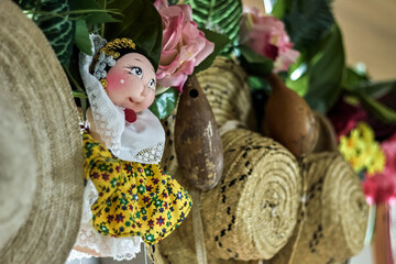 decoration with a doll with a Panamanian skirt, hats, maracas, flowers, greens, wall, party,...