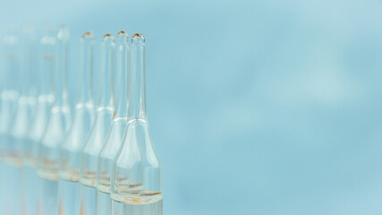 Glass ampoules for injection. Liquid medicine for preparation of solution. Pharmaceutical business, sale of medicines. Symbol of vaccination in hospital