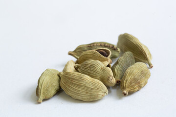 A pile of green Cardamom pods isolated on a white background,  popular spice in Indian food and many other cultures