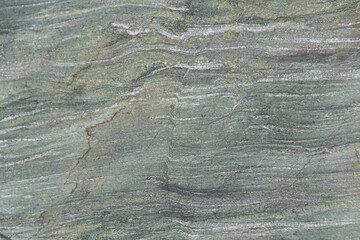 Slate stone wall as background. Textured surface of geological layer of soil